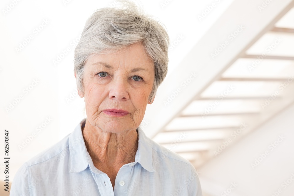 Retired woman frowning at the camera Retired woman frowning at the camera
