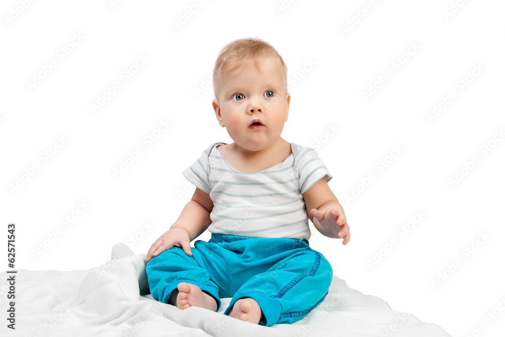 Cute little boy sitting on a white blanket isolated on white Cute little boy sitting on a white blanket isolated on white