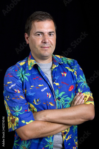 young happy man with a hawaiian shirt on black background