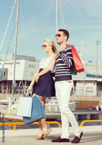 young couple in duty free shopping bags © Syda Productions