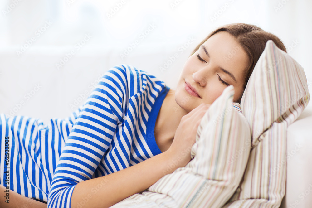 smiling teenage girl sleeping on sofa at home smiling teenage girl sleeping on sofa at home