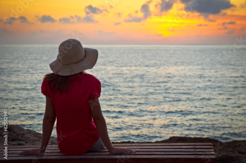 Young woman admires the sunset