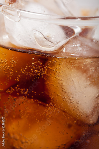 cola with ice cubes close up