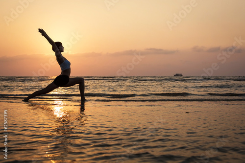 Yoga silhouette on the beach  virabhadrasana pose