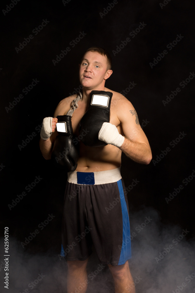 Muscular fit young boxer preparing for a fight Muscular fit young boxer preparing for a fight