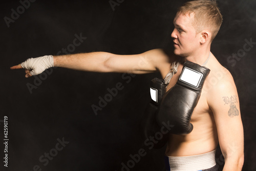 Fit young boxer standing pointing