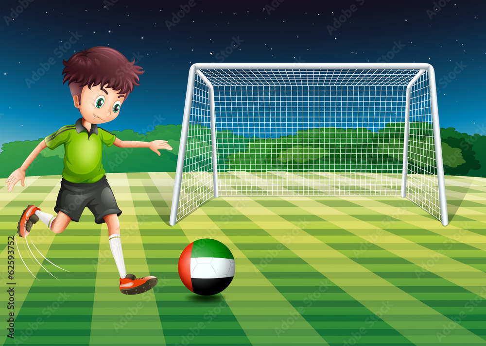 Fototapeta premium A male athlete kicking the ball with the flag of the United Arab