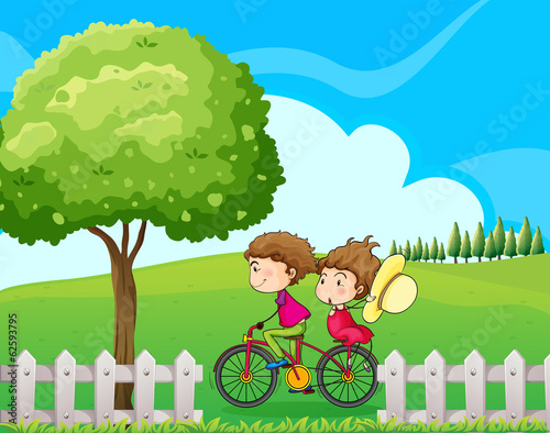 A boy biking with his girlfriend