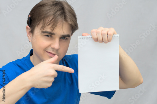 Man with empty paper of notebook photo