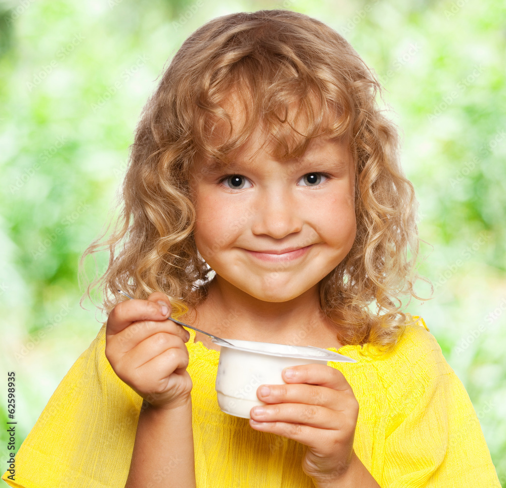 Little girl eating yogurt at summer Little girl eating yogurt at summer