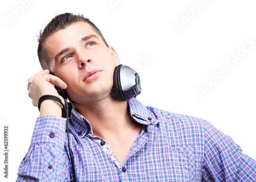 Attractive young man wearing headphones on white background
