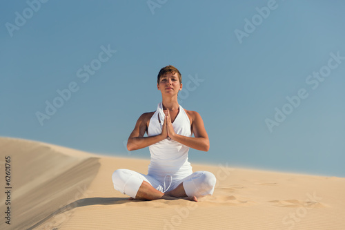 Yoga meditation on the beach, healthy female body in peace