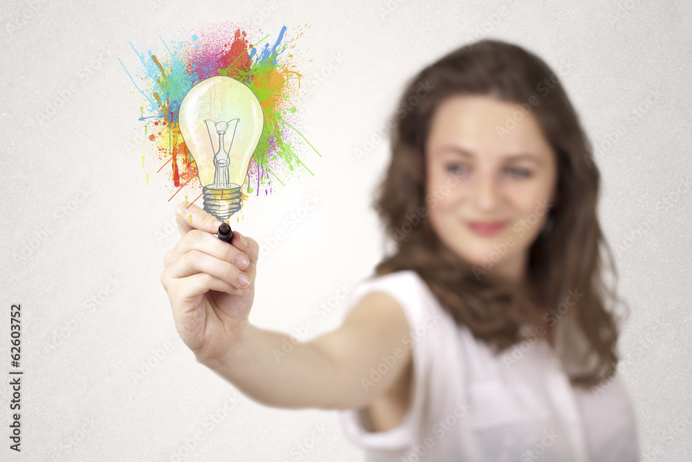 Young lady drawing a colorful light bulb with colorful splashes Young lady drawing a colorful light bulb with colorful splashes