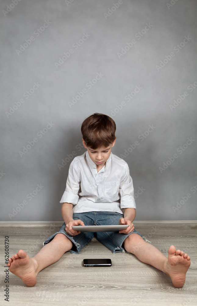 Fototapeta premium Boy playing on tablet