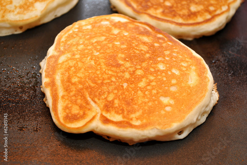 Pancakes Cooking on a Griddle