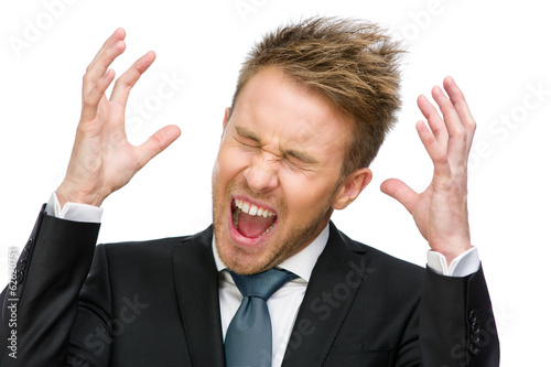 Portrait of scared and screaming businessman with hands up 