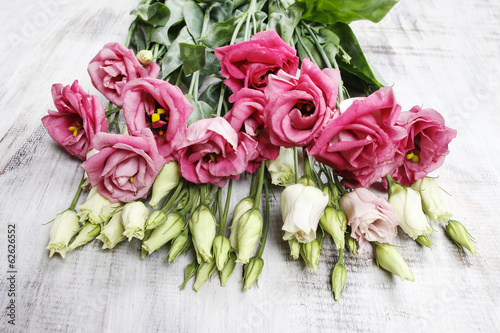 Bouquet of pink eustoma flowers on wooden table © agneskantaruk