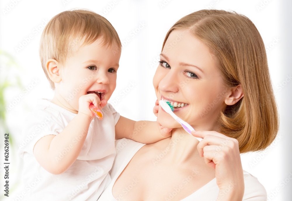 mother and daughter baby girl brushing their teeth together mother and daughter baby girl brushing their teeth together