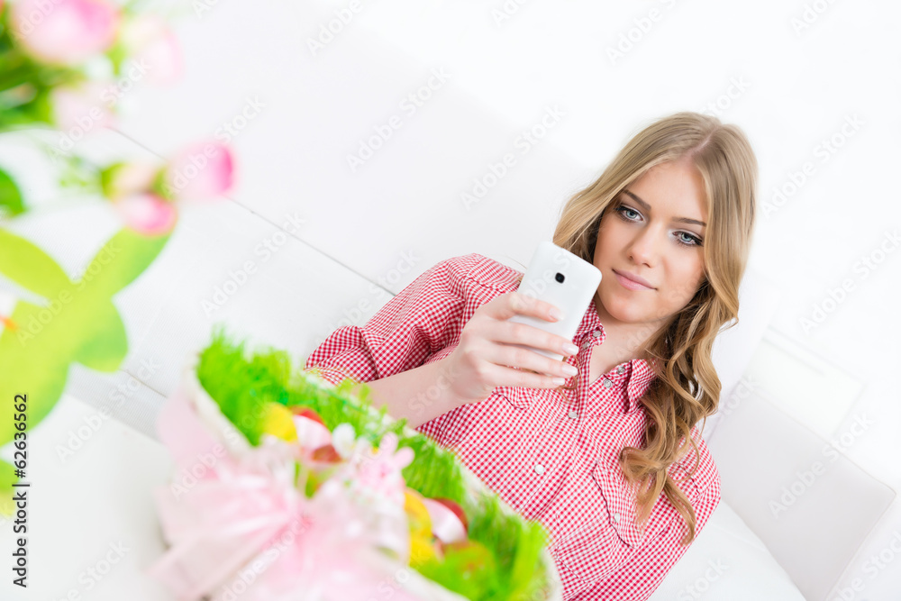 Woman sharing a photo messages of Easter eggs with her friends Woman sharing a photo messages of Easter eggs with her friends