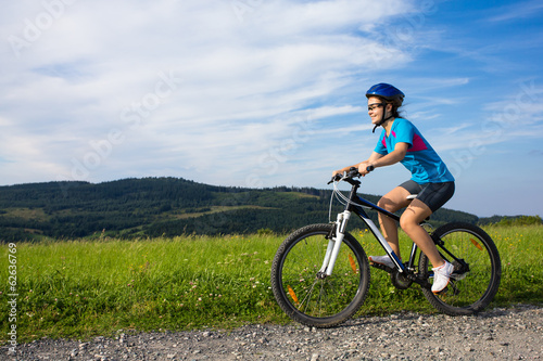 Fototapeta Naklejka Na Ścianę i Meble -  Healthy lifestyle - teenage girl biking