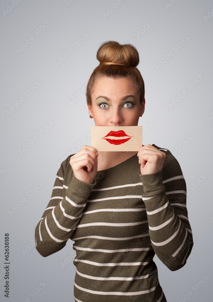 Happy pretty woman holding card with kiss lipstick mark Happy pretty woman holding card with kiss lipstick mark