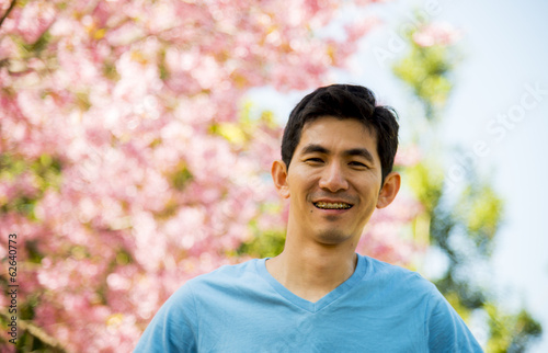 Smiling Blue man with pink cherry flower tree
