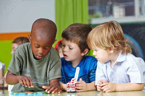 Kinder spielen im Kindergarten mit Bausteinen photo