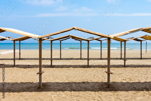 Rows of the palm leaf sun shades on the beach