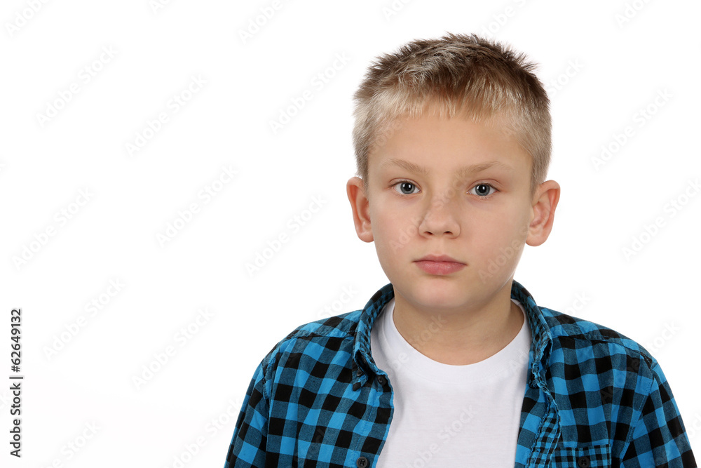Handsome pensive young boy looking straight at the camera Handsome pensive young boy looking straight at the camera