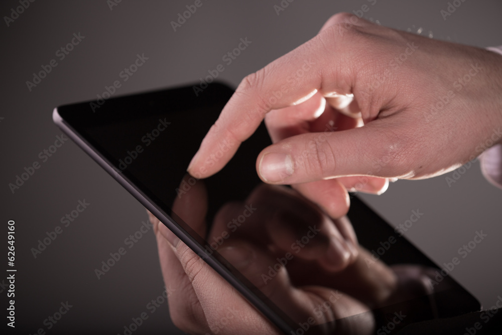 Hand touching digital tablet