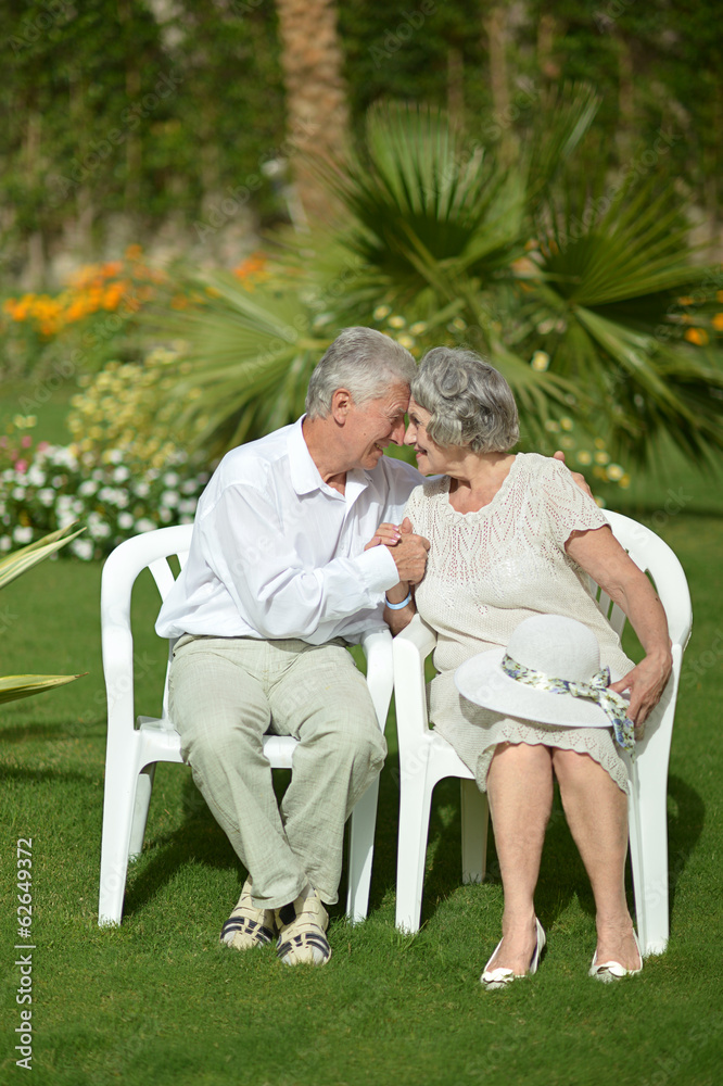 Senior couple sitting at tropic garden Senior couple sitting at tropic garden