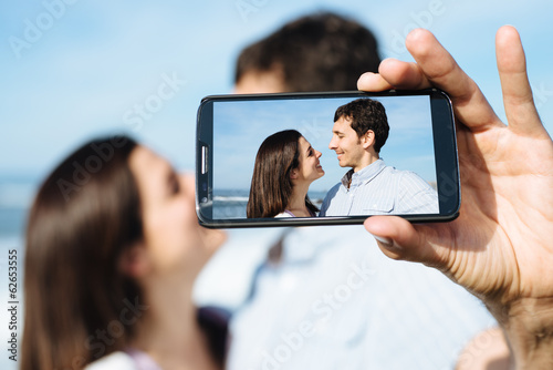 Lovers on travel taking smartphone selfie photo photo