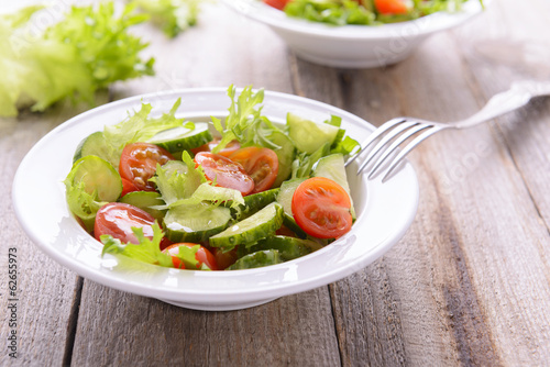 Salad from cucumbers and tomatoes in white plate