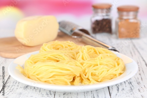 Composition with tasty spaghetti, grater, cheese, and spices