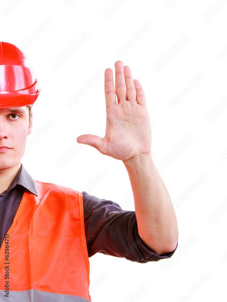 Man worker in safety vest and hard hat showing stop hand