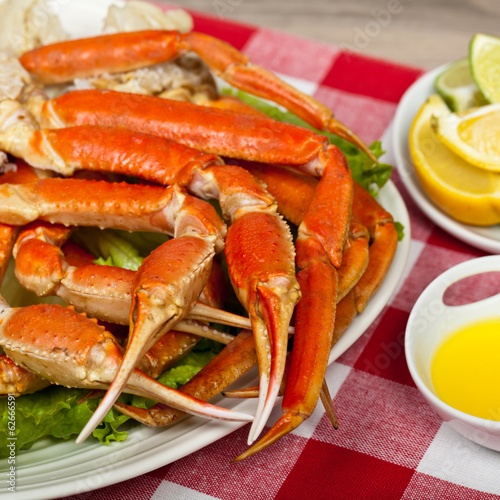 Snow Crab legs with fresh lemon slices and butter sauce