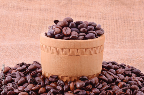 Pile of coffee beanson sackcloth background photo