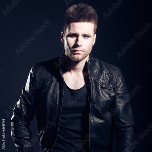 Portrait of handsome stylish man in elegant black suit