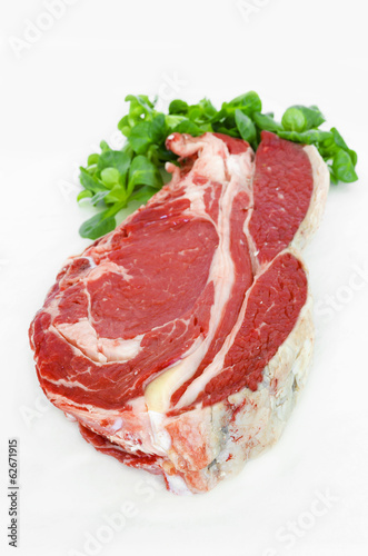 Pieces of crude meat, beef steak on white. Isolated