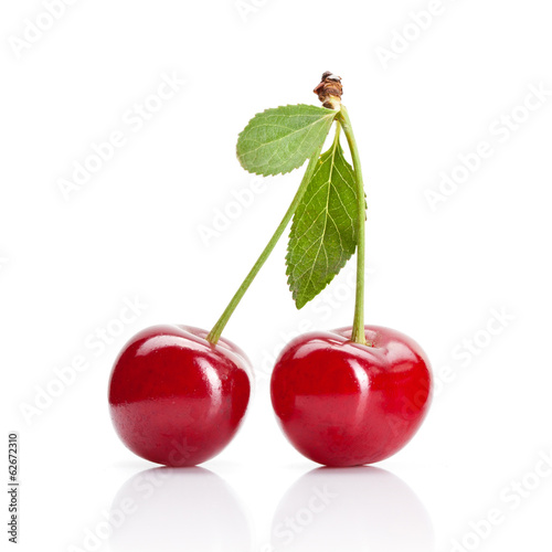 Red cherry with leaves isolated on white