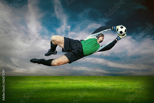 Football goalkeeper in action outdoors © Andrii IURLOV