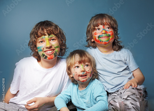 three cheerful brothers with painted faces
