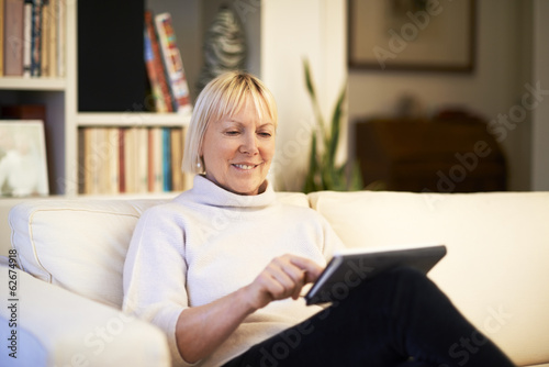 Obraz na płótnie senior woman using touch pad device