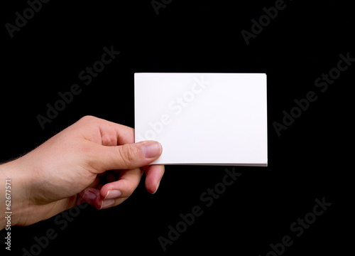 Female Hand Holding White Blank Card on Black Background