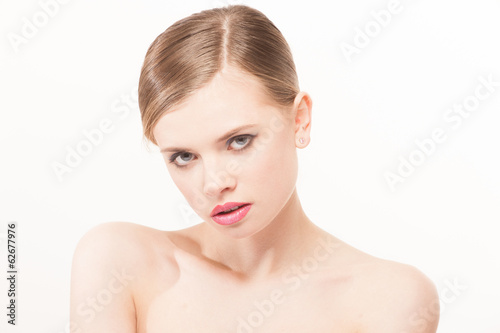 Portrait of beautiful young woman with clean face. High key shot