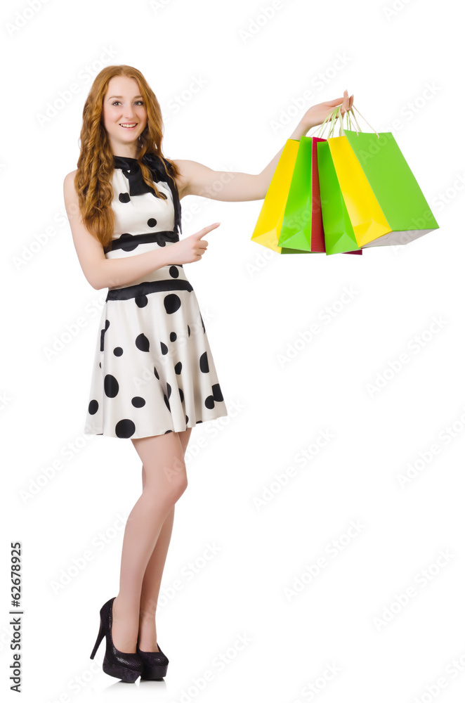Young woman with shopping bags on white