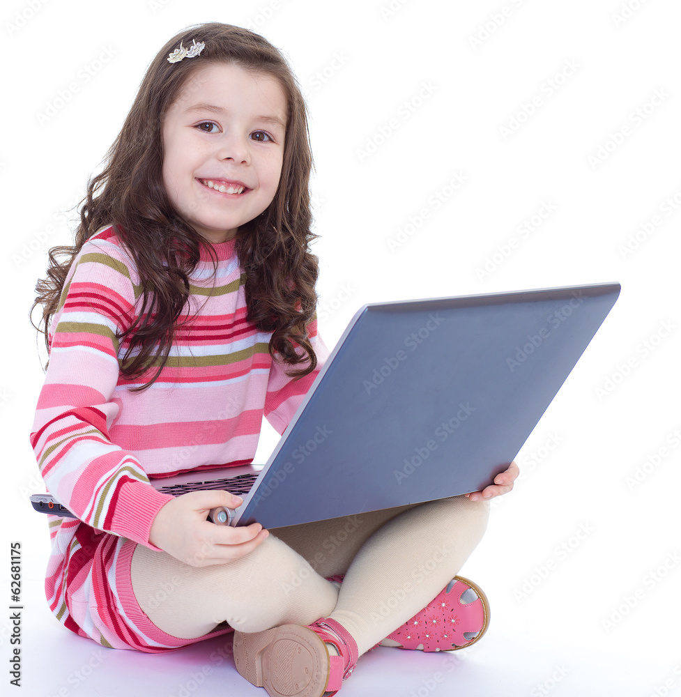 little girl holding a laptop on his knees little girl holding a laptop on his knees