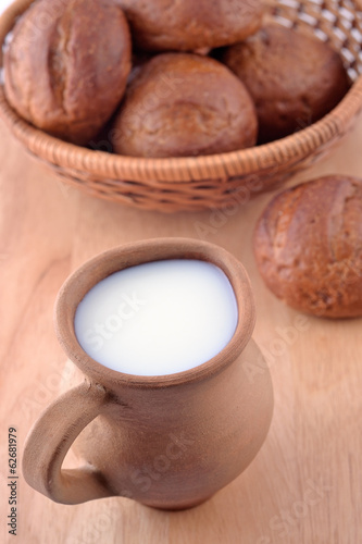Ceramic jug with milk and bread