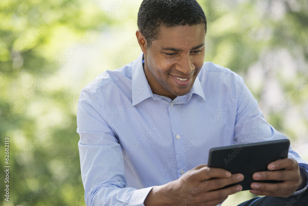 Summer. Business People. A Man Sitting Using A Digital Tablet, Keeping In Touch. Summer. Business People. A Man Sitting Using A Digital Tablet, Keeping In Touch.