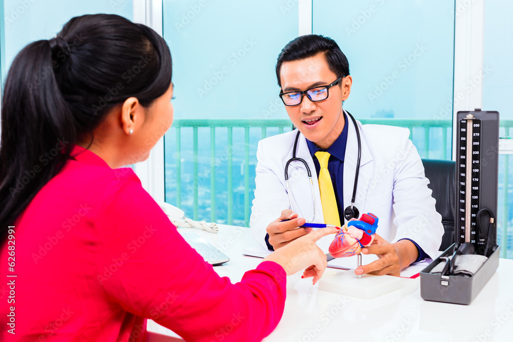 Asian doctor with patient in medical surgery Asian doctor with patient in medical surgery
